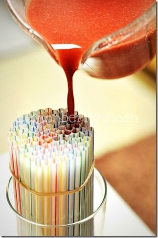 a glass filled with lots of different colored straws