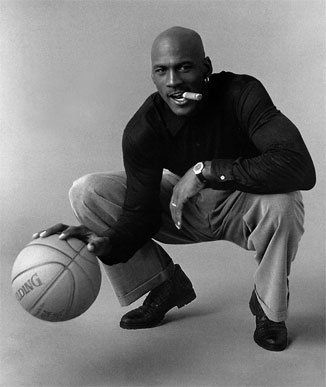 a black and white photo of a man with a mustache on his face holding a basketball