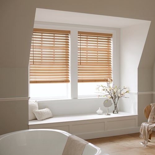 a bath room with a tub and a window