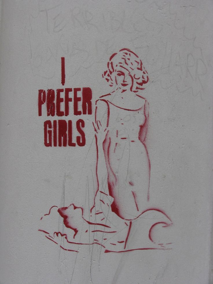 graffiti on the side of a building that says, i prefer girls with red ink