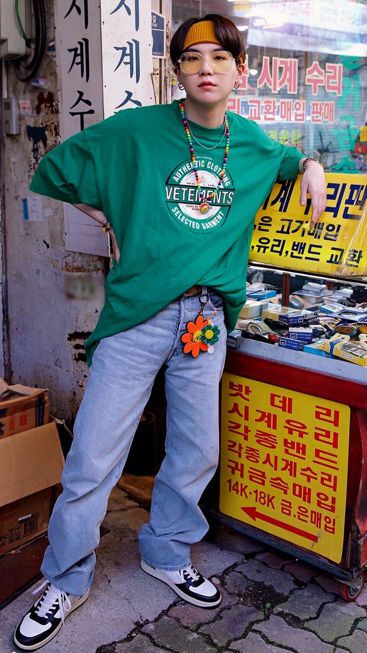 a man standing in front of a store with his hands on his hips