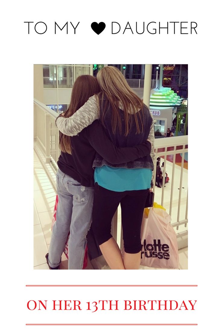 two women hugging each other in front of a sign that says, to my daughter on her 13th birthday