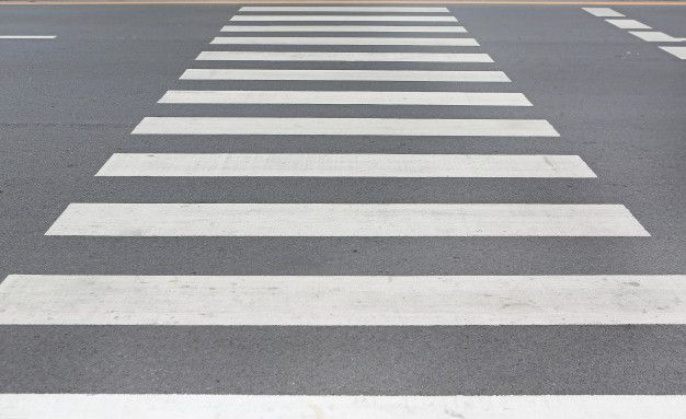 an empty parking lot with white lines painted on the pavement and no cars in sight