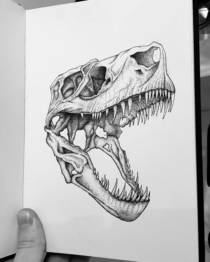 a drawing of a t - shirt with a dinosaur's skull on it, in black and white