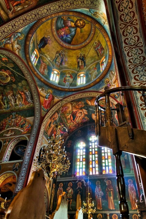 the inside of a church with many paintings on it