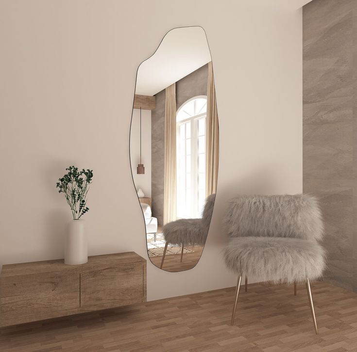 a mirror sitting on top of a wall next to a chair