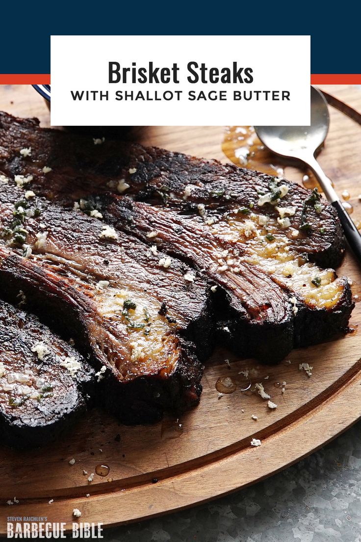 steaks with salt and pepper on a wooden cutting board next to a knife and fork