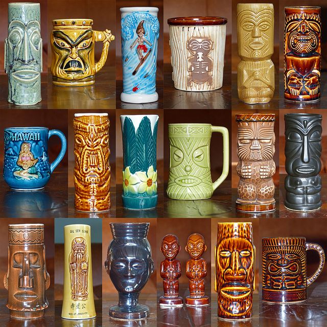 many different colored glass mugs lined up on a table