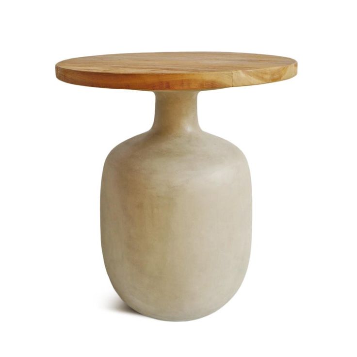 a small white vase with a wooden top on a white background and an empty table underneath it