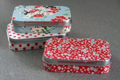 three tins with flowers and polka dots on them