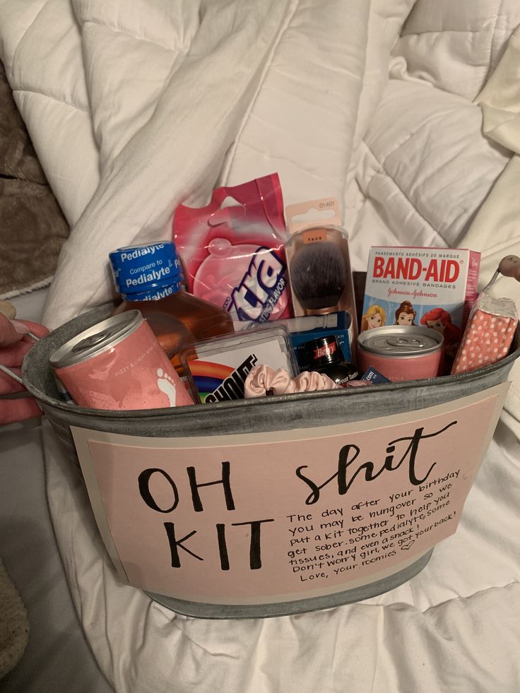 a bucket filled with lots of stuff on top of a bed