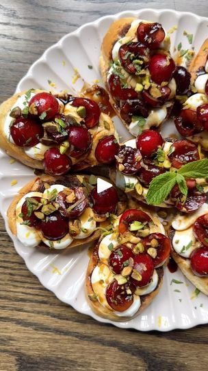 a white plate topped with cranberry and goat cheese appetizers on top of a wooden table