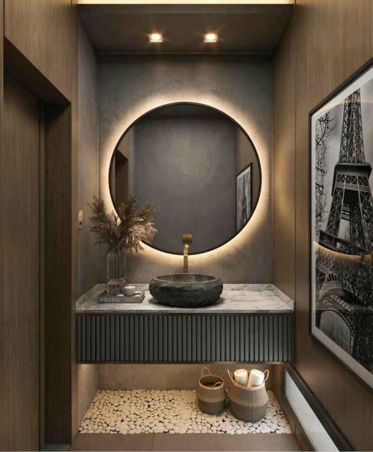 a bathroom with a round mirror above the sink