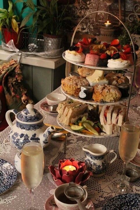 a table topped with plates and cups filled with food