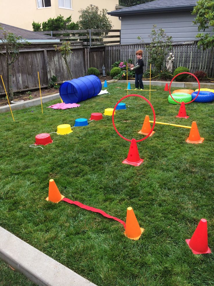 children playing in the yard with plastic cones and obstacles