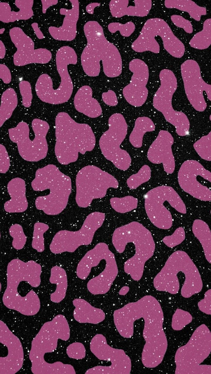 pink and black animal print fabric with glitters on the top, in front of a dark background