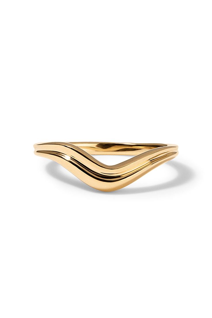 a yellow gold ring with wavy lines on the side, set against a white background