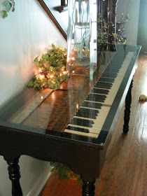 an old piano keyboard has been turned into a table i am in love