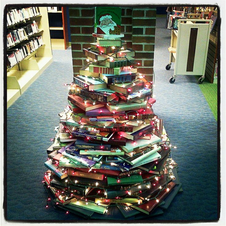 a christmas tree made out of books in a library