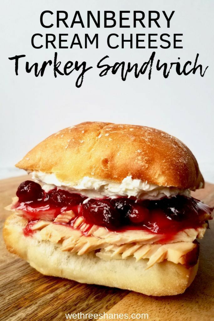 cranberry cream cheese turkey sandwich on a wooden cutting board with text overlay