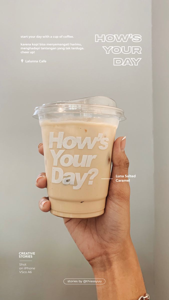 a hand holding up a drink with the words how's your day written on it