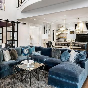 a living room filled with blue couches and furniture