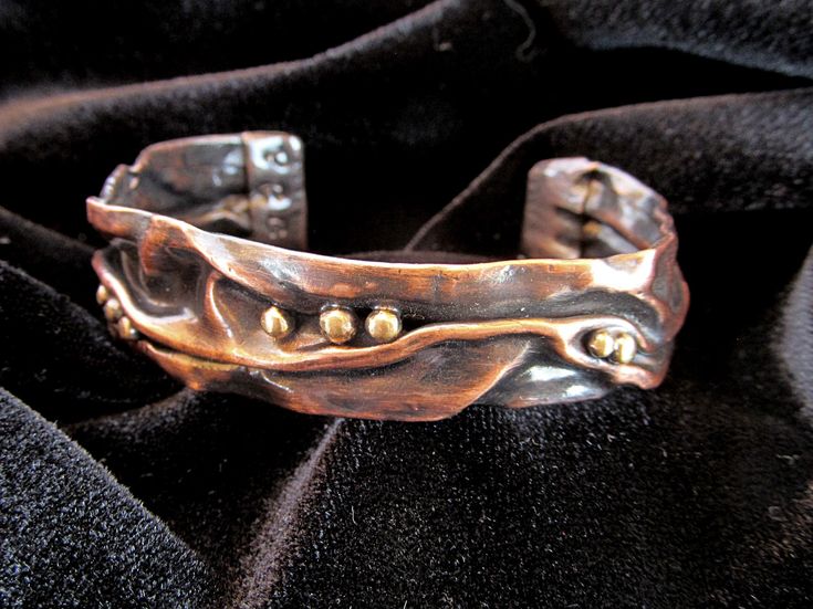 "This is a handmade mixed metal copper and brass cuff bracelet. The appearance reminds me of bubbles floating on water.  It as a unique, one-of-a-kind item. It is lightweight and comfortable but very strong and is appropriate for dressy as well as casual wear. It will last a lifetime. Creation of this bracelet is extremely labor intensive. I created this in my home studio starting out with sheet copper and brass wire. Steps involved in its creation include several rounds of cutting, hammering, f Handmade Copper Bracelet, Fold Forming, Silver Cuff Ring, Melting Metal, Brass Cuff Bracelet, Dark Sea, Copper Cuff Bracelet, Brass Cuff, Copper Cuff