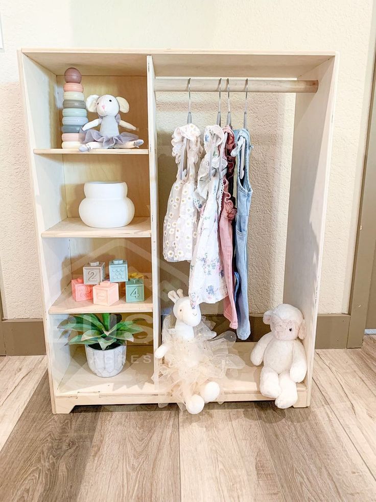 a baby's closet with stuffed animals and clothes