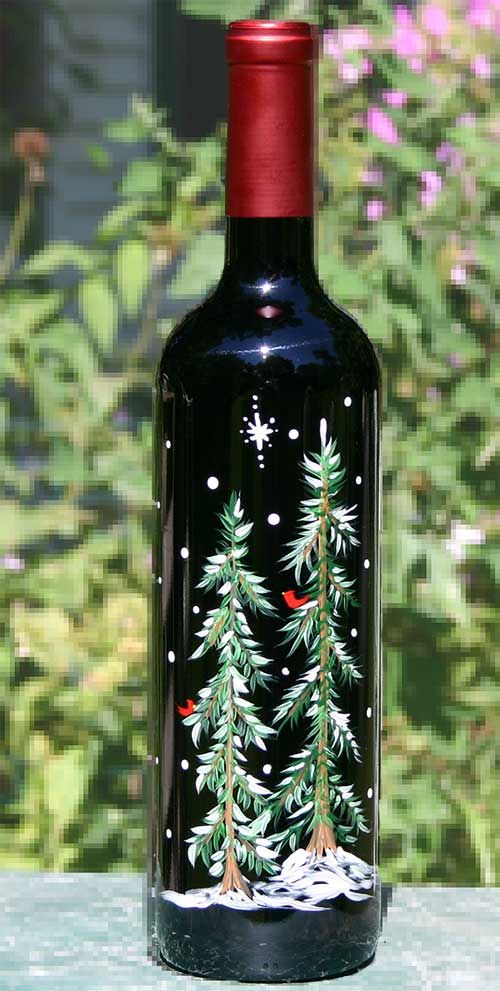 a black bottle with christmas trees painted on it