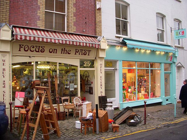 a store front with lots of furniture outside