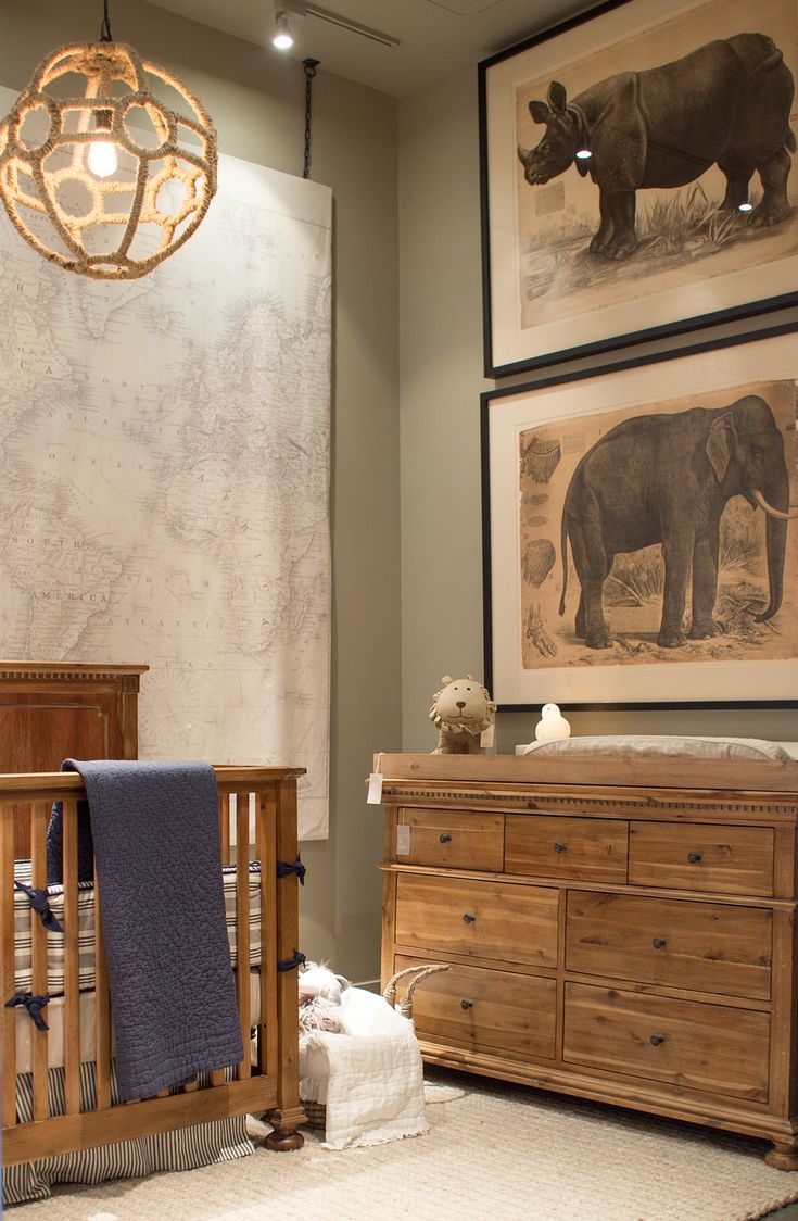 a baby's room with two cribs and pictures on the wall above them