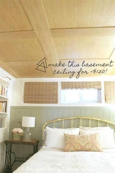 a bed sitting under a wooden ceiling next to a book shelf with books on it