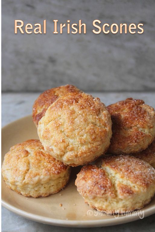 four biscuits on a plate with the words real irish scones