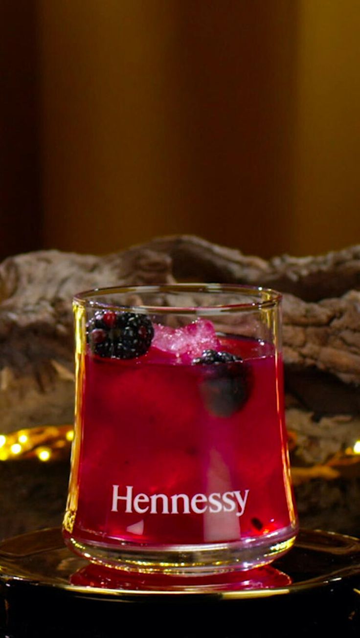 a glass filled with liquid sitting on top of a table