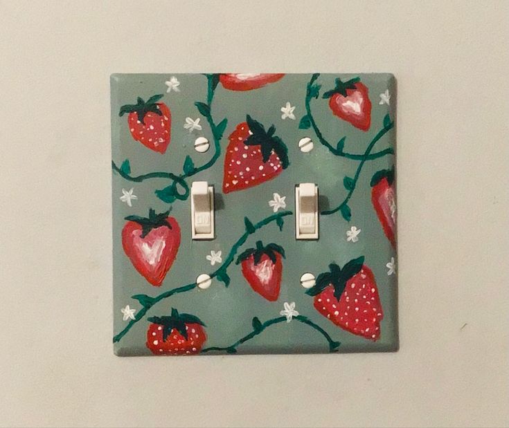 a light switch cover with strawberries on it