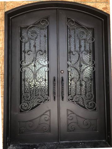 a black double door with intricate iron work