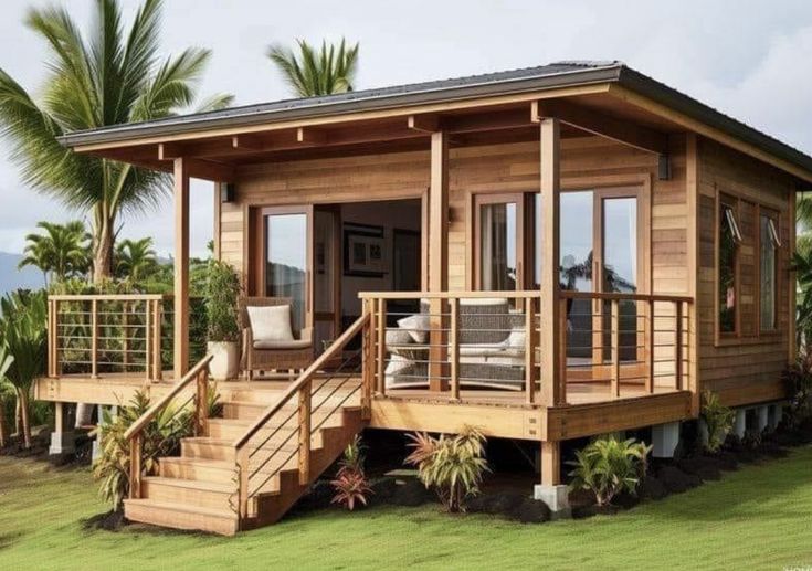 a small wooden house sitting on top of a lush green field next to palm trees