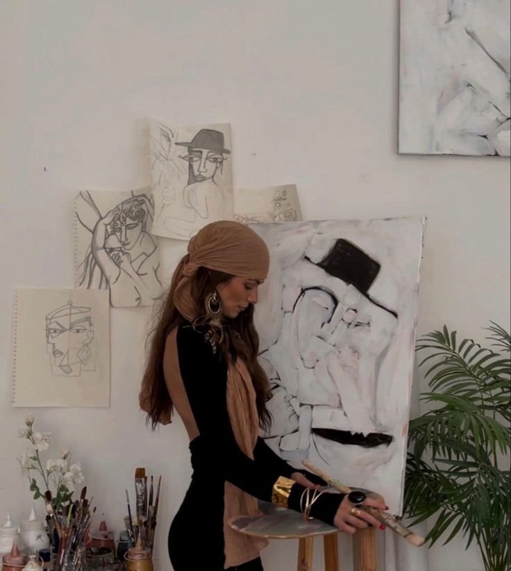 a woman is standing in front of a painting