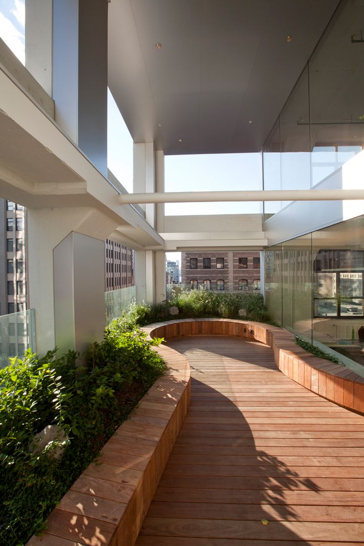 a long wooden walkway leading to the top floor of a building with lots of windows