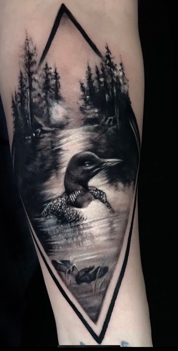 a black and white tattoo with an image of a bird in the middle of it