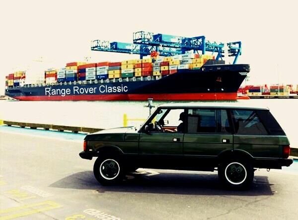 an suv driving past a large cargo ship