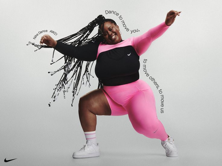 a woman in pink and black is dancing with words written all over her body on the wall behind her