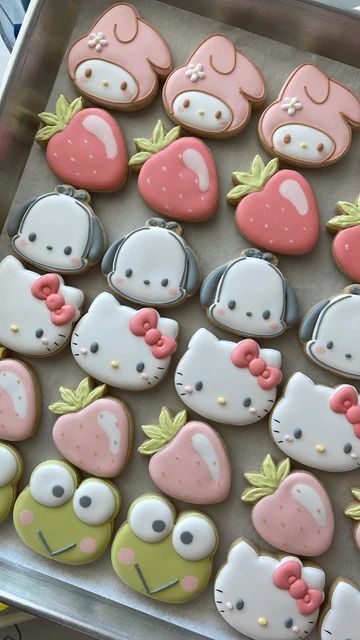 some hello kitty cookies are on a tray