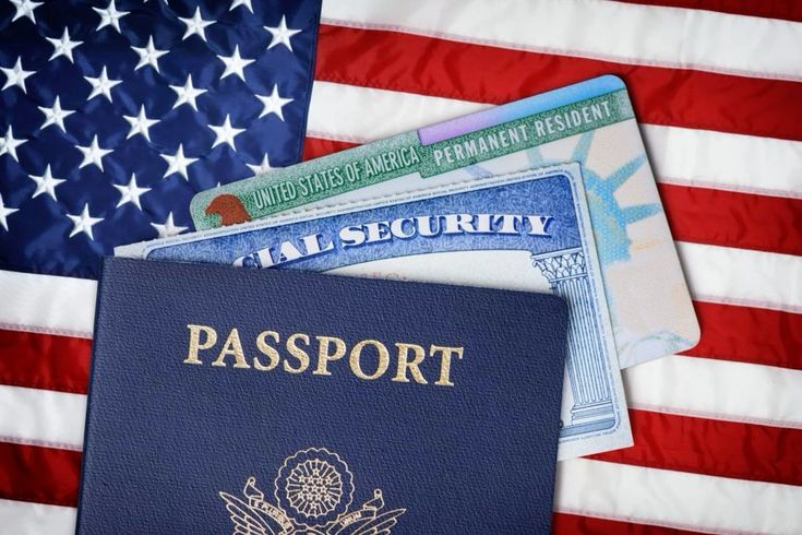 an american passport sitting on top of a us flag next to a visa card and credit cards