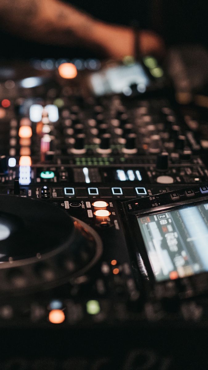 a dj mixing music in front of his equipment