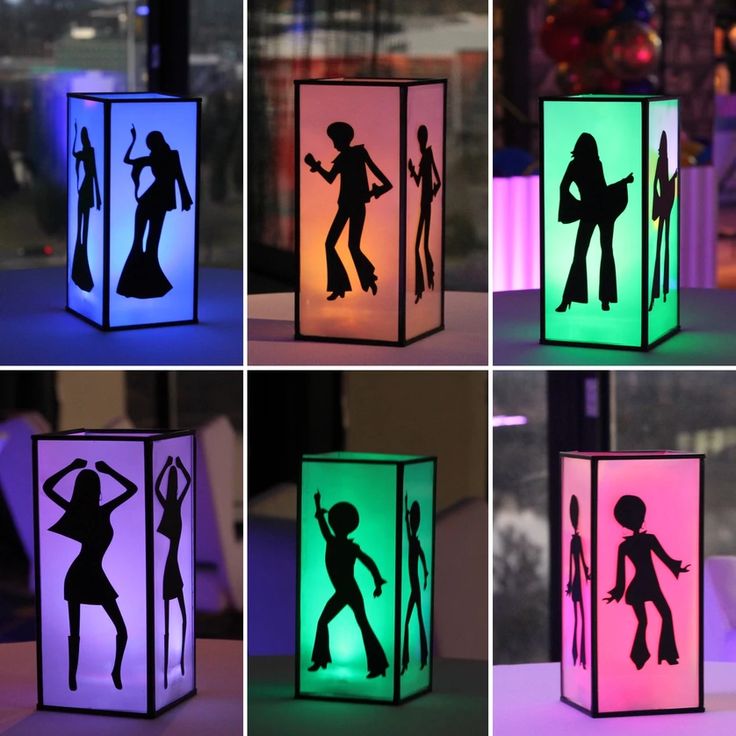 the silhouettes of people are projected in different colors on this cube light up box