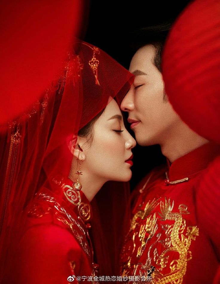 two people dressed in red are kissing each other