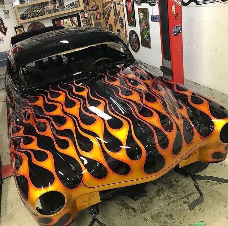 an orange and black car with flames on it