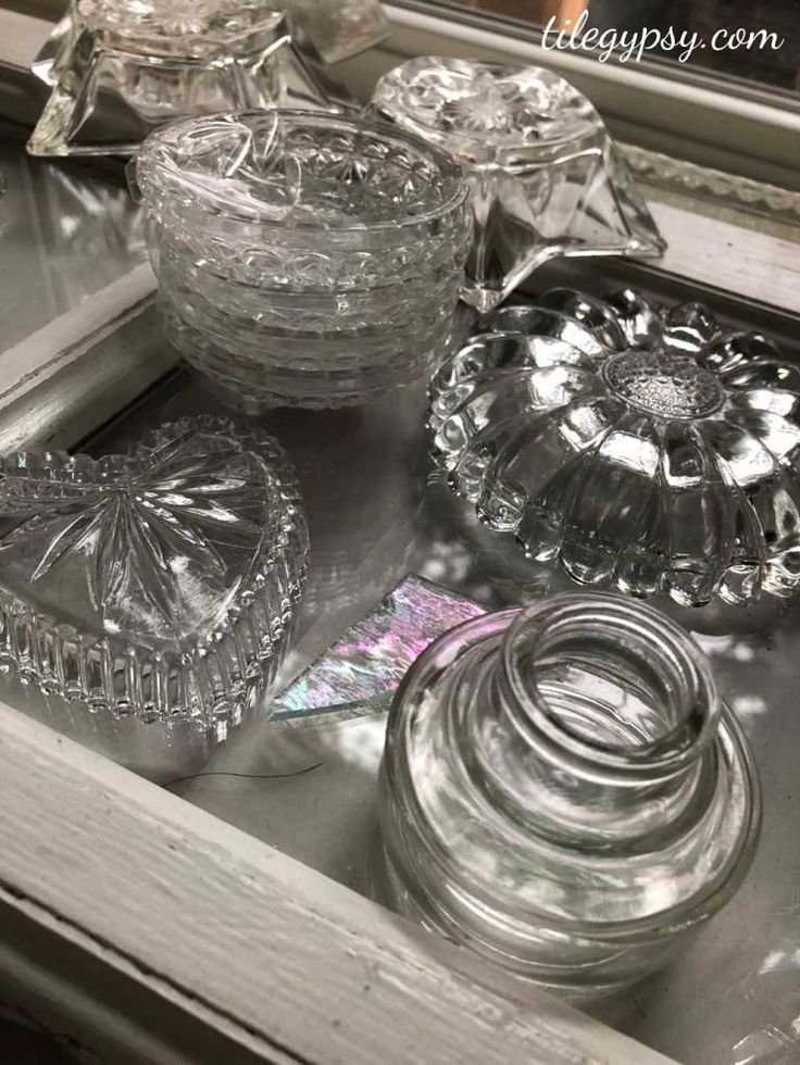 some glass dishes are sitting on the sink