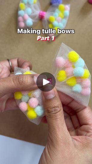 the video shows how to make bows with pom - poms